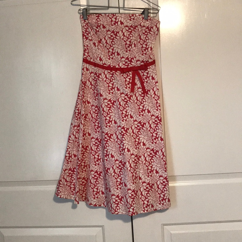 Red with white flower pattern dress with red bow.